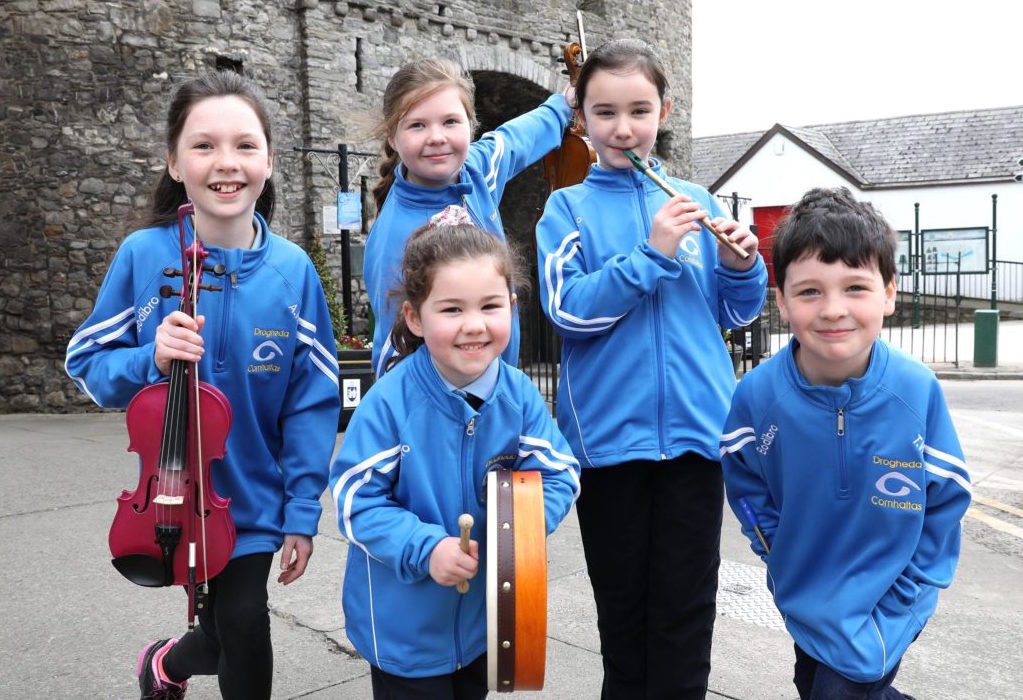Group of young musicians from Drogheda Comhaltas with fiddle, bodhrán and flute gathered together for a photo. Image Tommy McDermot