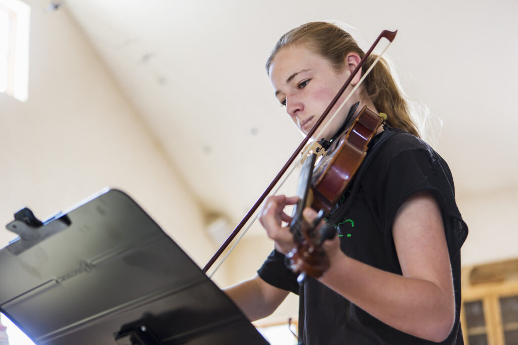 Teenage girl playing fiddle